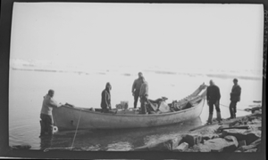 Image of Six men with supplies/sledge by big boat